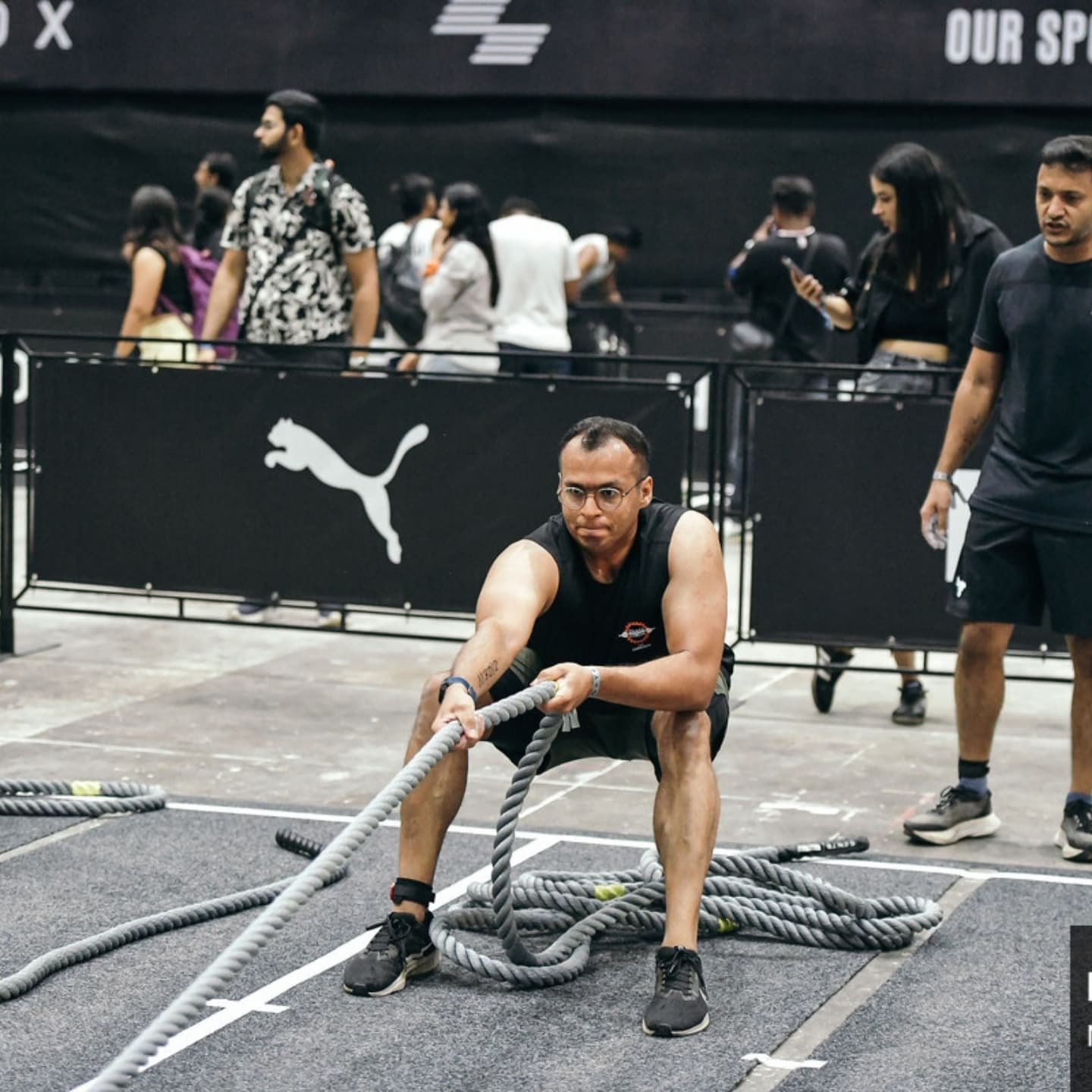 A Chakra member training with battle ropes at a fitness event